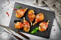 Bacon wrapped chicken legs on a black background Royalty Free Stock Photo