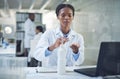 The only bacteria I want is under the microscope. a scientist disinfecting her hands while conducting research in a Royalty Free Stock Photo