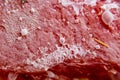 Closeup of a bacterial cololny with mold cells on red bacground