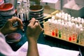 Bacterial Inoculation on a test tube agar culture media using inoculation loop by scientist lab technician in a microbiology labor