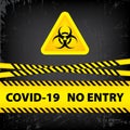 Bacteriological hazard sign and No Entry COVID-19. Concept of Bacteriological hazard coronavirus. Yellow ribbon with text COVID