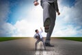 The bad angry boss kicking employee in business concept Royalty Free Stock Photo