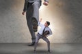 Bad angry boss kicking employee in business concept Royalty Free Stock Photo