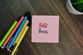 Bad Boss write on sticky notes isolated on Wooden Table Royalty Free Stock Photo