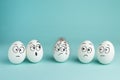Bad character concept. Prickly egg. Five white eggs with drawn faces on a blue background Royalty Free Stock Photo