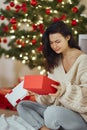 Bad Christmas Gift - Disappointed and Unhappy Woman with Opened Present Box Indoors at Home Royalty Free Stock Photo