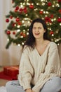 Bad Christmas Gift - Disappointed and Unhappy Woman During Winter Holidays Indoors at Home Royalty Free Stock Photo