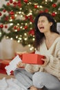 Bad Christmas Gift - Disappointed and Unhappy Woman with Opened Present Box Indoors at Home Royalty Free Stock Photo