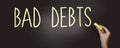 Bad debts words phrase with chalk on blackboard. Financial liabilities bankruptcy debt crisis concept