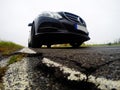 Bad, destructed road and car