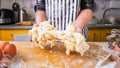 Bad dough. Inexperienced unskillful woman cook in an apron holds unsuccessful sticky dough in her hands.