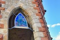 Bad DÃÂ¼rkheim, Germany, Ogive stained lass window above entrance of flag tower with vineyard theme Royalty Free Stock Photo