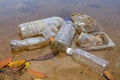 Bad environmental habit of improper disposal of non-biodegradable PVC cups and bottles in a lake. Selective focus.