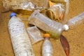 Bad environmental habit of improper disposal of non-biodegradable PVC cups and bottles in a lake. Selective focus.