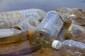 Bad environmental habit of improper disposal of non-biodegradable PVC cups and bottles in a lake. Selective focus.