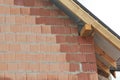 A bad example of masonry, bricklaying, using wet bricks under the roofing construction