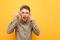 Bad-eyed, bewildered man looks into the camera and adjusts his glasses, wears a shirt and mustache. Funny surprised nerd looks Royalty Free Stock Photo