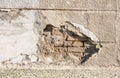 Bad foundation base on old house or building cracked plaster facade wall with brick background Royalty Free Stock Photo