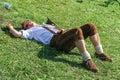 BAD HINDELANG, BAVARIA, GERMANY - SEPTEMBER 10 2011: Mountain Farmer lying on ground relaxing after the traditional