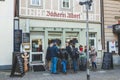 People socializing and drinking coffee in a cafe outdoor area on Market Place in Bad Kissingen, Germany