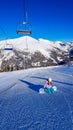 Bad Kleinkirchheim - A snowboarder sitting under a cable car