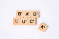 Bad luck word on board game alphabet letter with K alphabet falling down . isolated on white background
