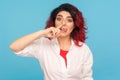 Bad manners, misconduct. Portrait of funny comical hipster woman with fancy red hair picking her nose