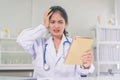 Bad medical results female doctor looking at computer tablet and looking confused in lab coat hospital Royalty Free Stock Photo