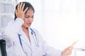 Bad medical results female doctor looking at computer tablet and looking confused in lab coat hospital Royalty Free Stock Photo