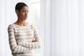 Bad Mood Concept. Upset African American Lady Standing Near Window At Home Royalty Free Stock Photo