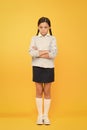 In bad mood. unhappy girl in school uniform. education concept. back to school. smart little girl on yellow background