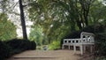 Bad Muskau Park, Germany. White wooden bench in Muskau Park.