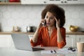 Bad News. Stressed Black Woman Looking At Laptop And Talking On Cellphone Royalty Free Stock Photo