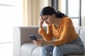 Bad News. Upset Indian Woman Reading Message On Smartphone At Home Royalty Free Stock Photo