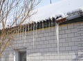 Bad old metal rain gutter and icicles Royalty Free Stock Photo