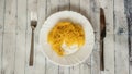 Bad pasta server table fork and knife on wooden table, rotten pasta, dry white plate Royalty Free Stock Photo