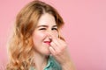 Bad rancid smell odor woman holding nose grimacing Royalty Free Stock Photo