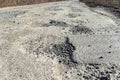 Bad road, cracked asphalt with potholes and big holes. Potholes on the road with stones on the asphalt. The asphalt surface is Royalty Free Stock Photo