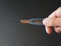 Bad rusty Clerical knife in a man`s hand.