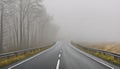 Bad weather driving - foggy hazy country road. Motorway - road traffic