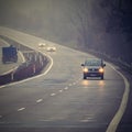 Bad weather driving - foggy hazy country road. Motorway - road traffic. Winter time Royalty Free Stock Photo