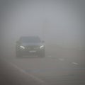 Bad weather driving - foggy hazy country road. Motorway - road traffic. Winter time Royalty Free Stock Photo