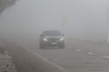 Bad weather driving - foggy hazy country road. Motorway - road traffic. Winter time