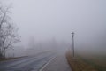 Bad weather driving - Foggy morning on a winding country road Royalty Free Stock Photo