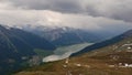 Bad weather front approaching over popular lake Reschensee and Reschen village in South Tyrol, Italy in the alps.