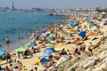 Badalona, Barcelona, Spain, June 14, 2021. Beach full of bathers with umbrellas lying in the sun