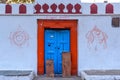 Old blue wooden door with red border in white wall at Badami, Karnataka, India Royalty Free Stock Photo