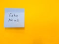 On a blue paper sticker it says - Fake news, on a yellow background.