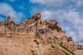 Badlands National Park - Landscape of eroded rock formations, clouds, and blue sky Royalty Free Stock Photo