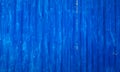 Badly painted waved metal sheet blue background